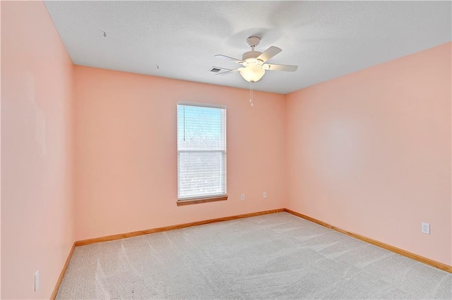 unfurnished room with ceiling fan and light carpet