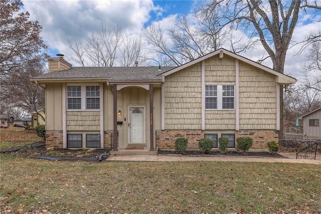 split foyer home with a front lawn