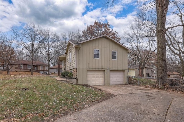 view of side of home featuring a lawn and a garage