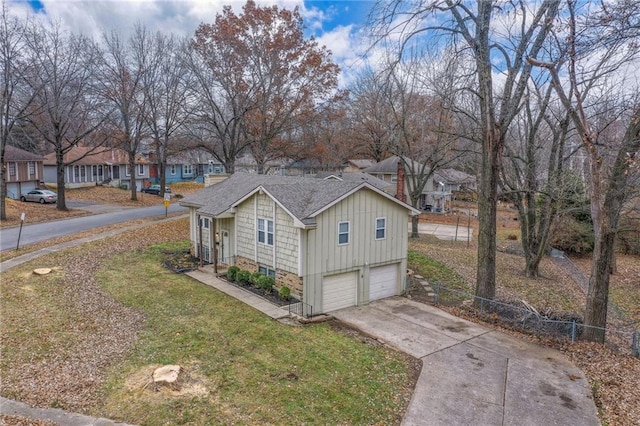 view of side of home with a garage and a yard