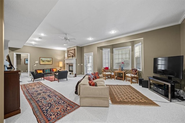 carpeted living room featuring plenty of natural light, ceiling fan, and ornamental molding