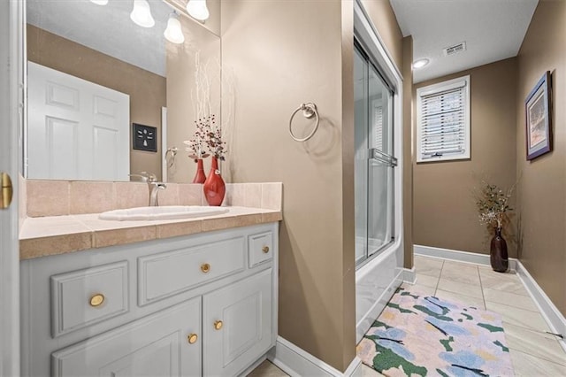 bathroom featuring shower / bath combination with glass door, vanity, and tile patterned floors