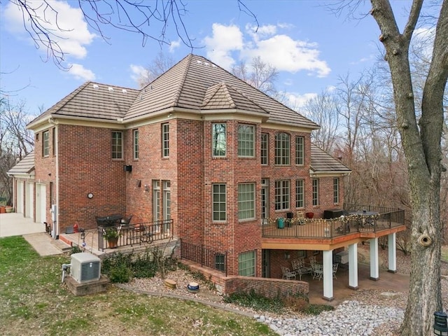 back of house with a deck and a garage