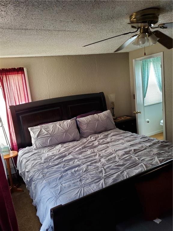 bedroom with a textured ceiling, ceiling fan, and carpet floors