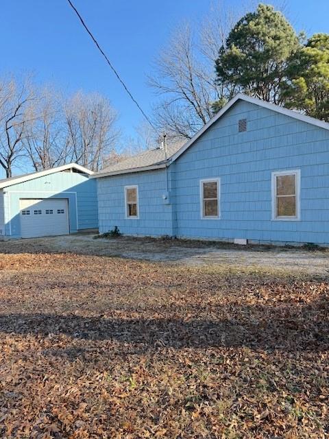 back of property featuring a garage