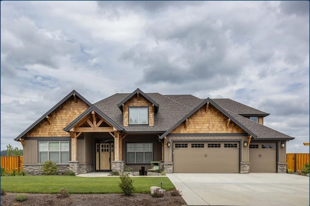 craftsman-style house featuring a garage and a front lawn