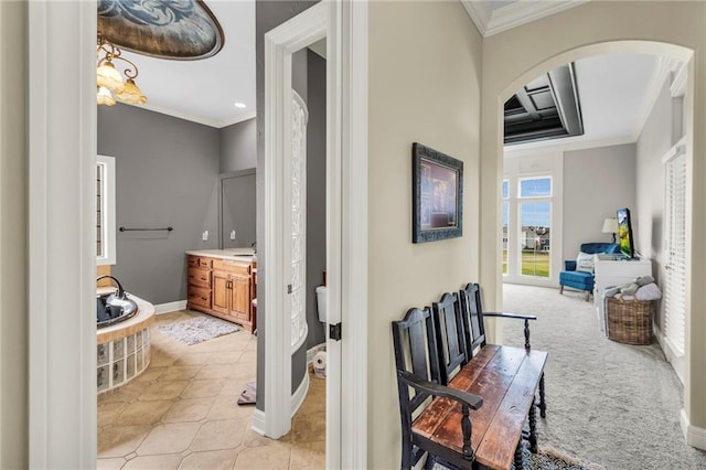 hallway featuring light colored carpet and ornamental molding