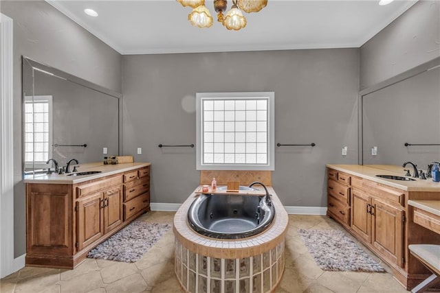 bathroom featuring a bathtub, vanity, and a notable chandelier