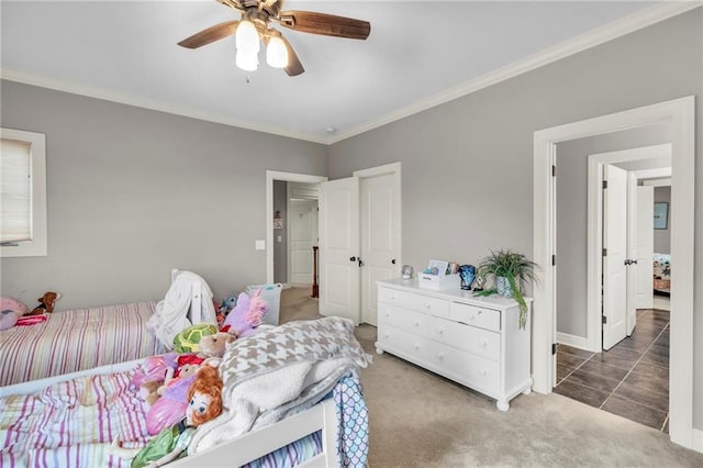 carpeted bedroom with ceiling fan and ornamental molding