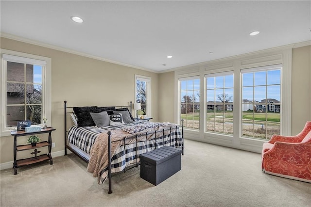 carpeted bedroom with ornamental molding and multiple windows