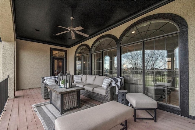 sunroom featuring ceiling fan