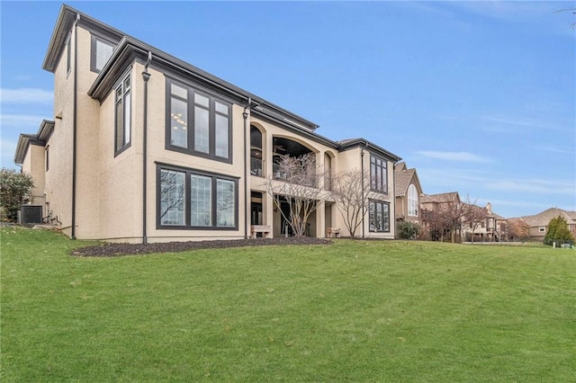 rear view of house featuring a yard