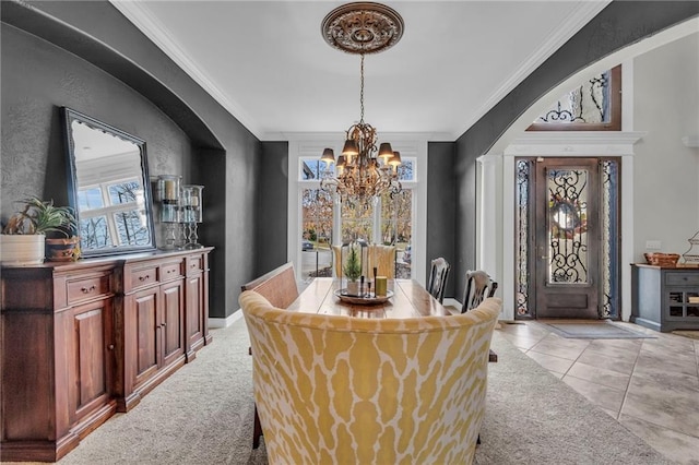 dining area with light colored carpet, crown molding, and a chandelier