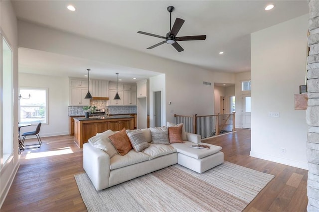 living room featuring hardwood / wood-style floors and ceiling fan