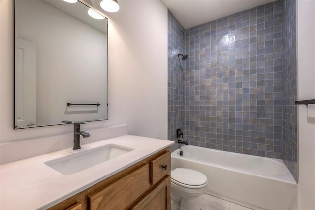 full bathroom with vanity, tiled shower / bath combo, and toilet