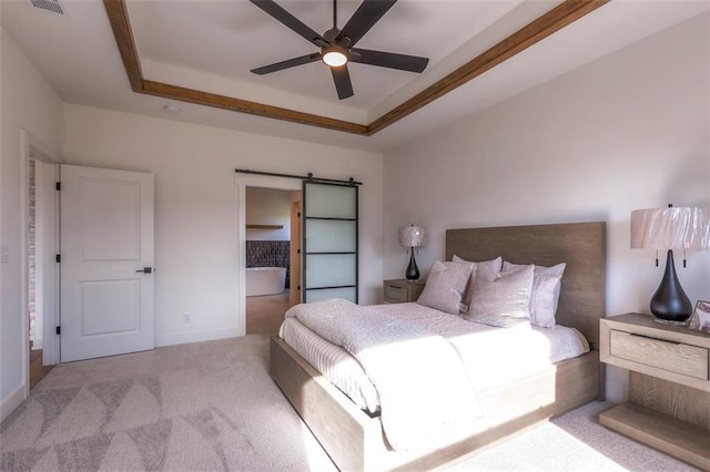 carpeted bedroom featuring ceiling fan, a barn door, and a raised ceiling