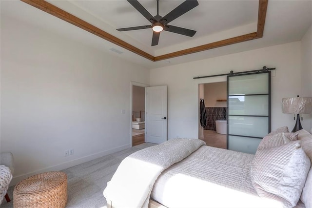 carpeted bedroom with ceiling fan, a raised ceiling, and a closet