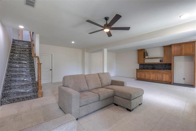 living room with ceiling fan and light colored carpet