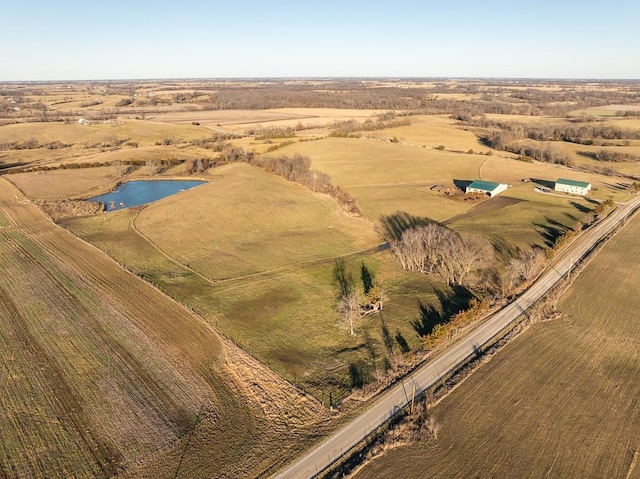 birds eye view of property featuring a water view and a rural view