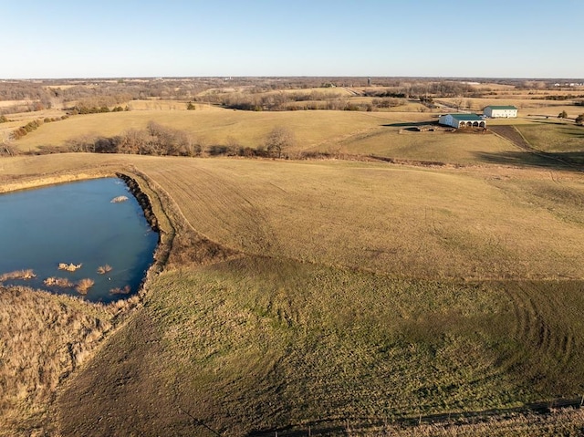 birds eye view of property with a rural view and a water view