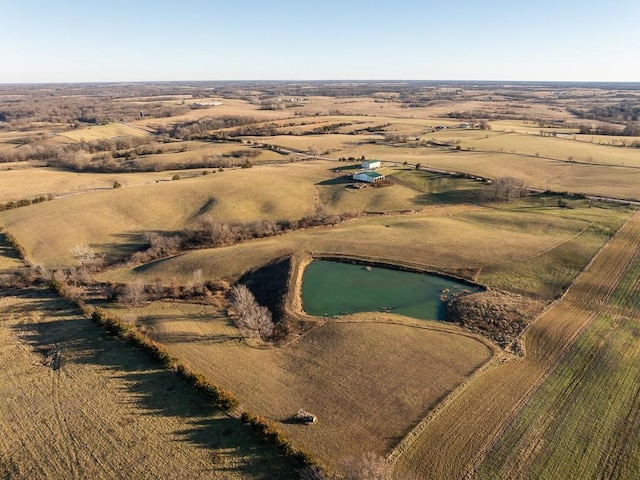 drone / aerial view featuring a rural view and a water view