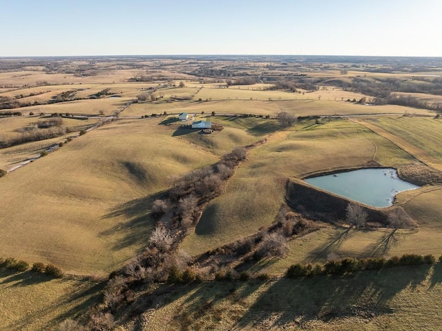 drone / aerial view featuring a rural view and a water view