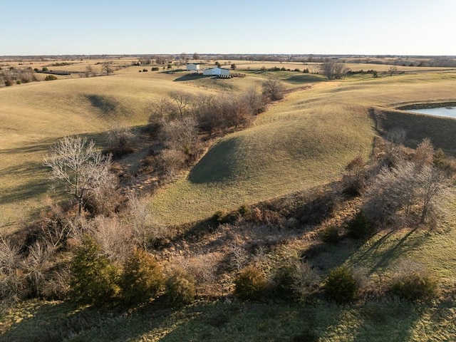 birds eye view of property featuring a water view and a rural view