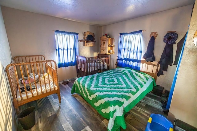 bedroom with dark hardwood / wood-style floors