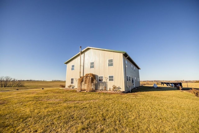 back of property featuring a lawn