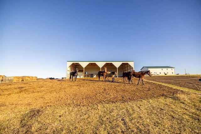 view of front facade with a rural view and an outdoor structure