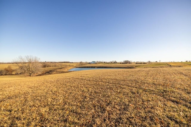 view of yard featuring a rural view and a water view