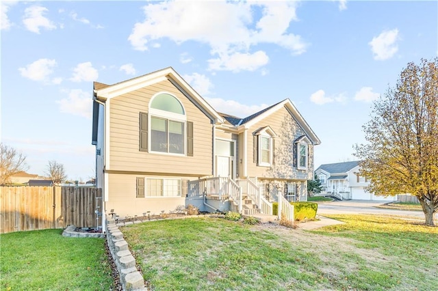 split foyer home with a front lawn