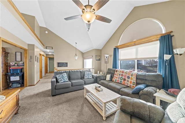 living room with ceiling fan, carpet, and high vaulted ceiling