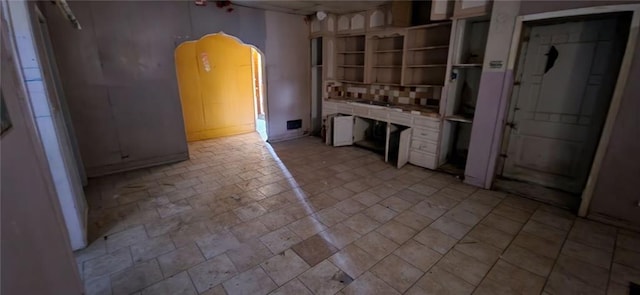 kitchen featuring tile counters and open shelves