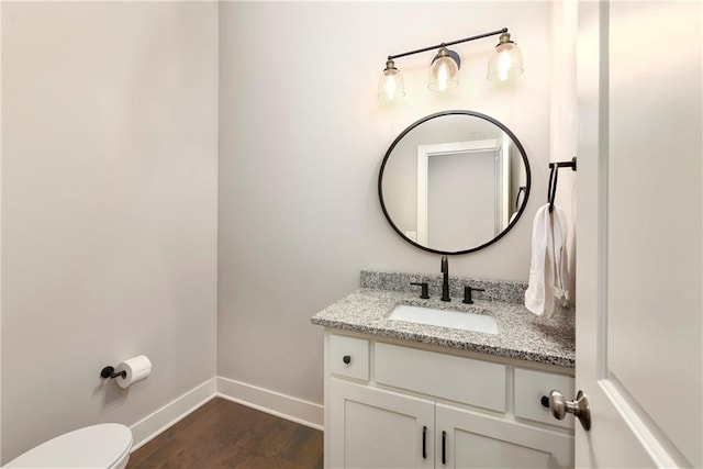 bathroom featuring hardwood / wood-style floors, vanity, and toilet