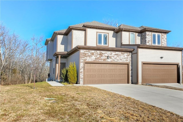 view of front of property with a garage and a front lawn