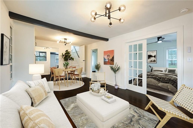 4412 N Jackson Ave, Kansas City, MO 64117 - living room featuring beamed ceiling, ceiling fan with notable chandelier, and wood-type flooring