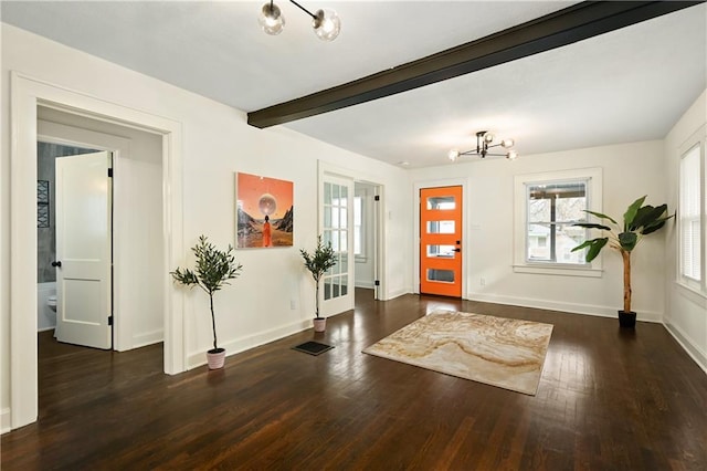 4412 N Jackson Ave, Kansas City, MO 64117 - entryway with beamed ceiling, dark hardwood / wood-style floors, and an inviting chandelier