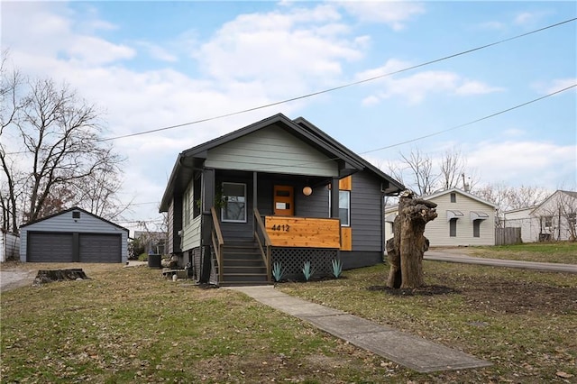 4412 N Jackson Ave, Kansas City, MO 64117 - bungalow featuring a porch, an outbuilding, a front yard, and a garage