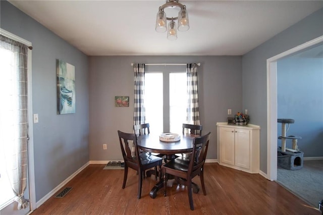 dining area featuring a wealth of natural light and dark hardwood / wood-style floors