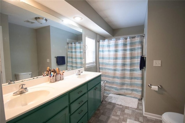 full bathroom with shower / bath combo with shower curtain, toilet, and vanity