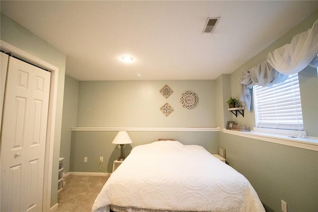 bedroom featuring a closet and light colored carpet