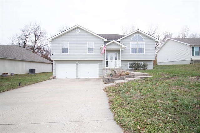 bi-level home with a garage and a front yard