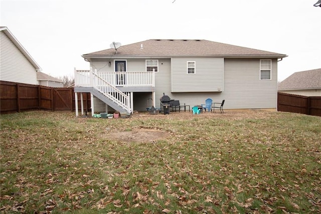 rear view of property featuring a lawn