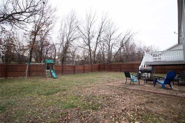 view of yard featuring a patio area and a playground