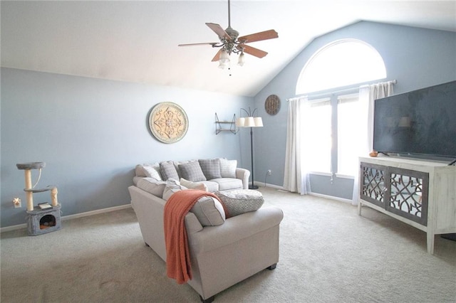 carpeted living room with ceiling fan and lofted ceiling