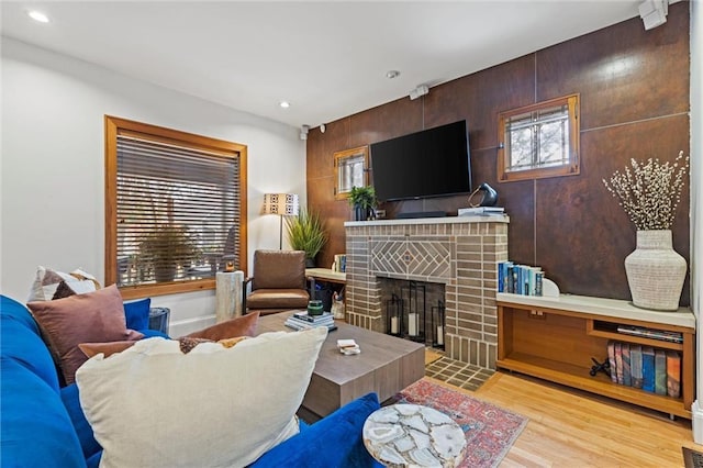 living room featuring a fireplace and light hardwood / wood-style flooring