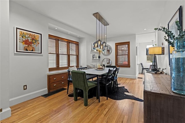 dining area with light hardwood / wood-style flooring