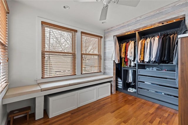 walk in closet with light hardwood / wood-style flooring and ceiling fan