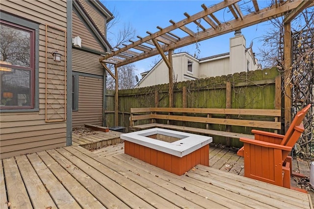 wooden terrace with a fire pit and a pergola